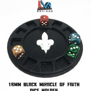 May include: Black dice holder with a white fleur-de-lis in the center. The holder has several compartments, each holding a die. The dice are various colors, including red, green, and brown. The text "16MM BLACK MIRACLE OF FAITH DICE HOLDER" is at the bottom.