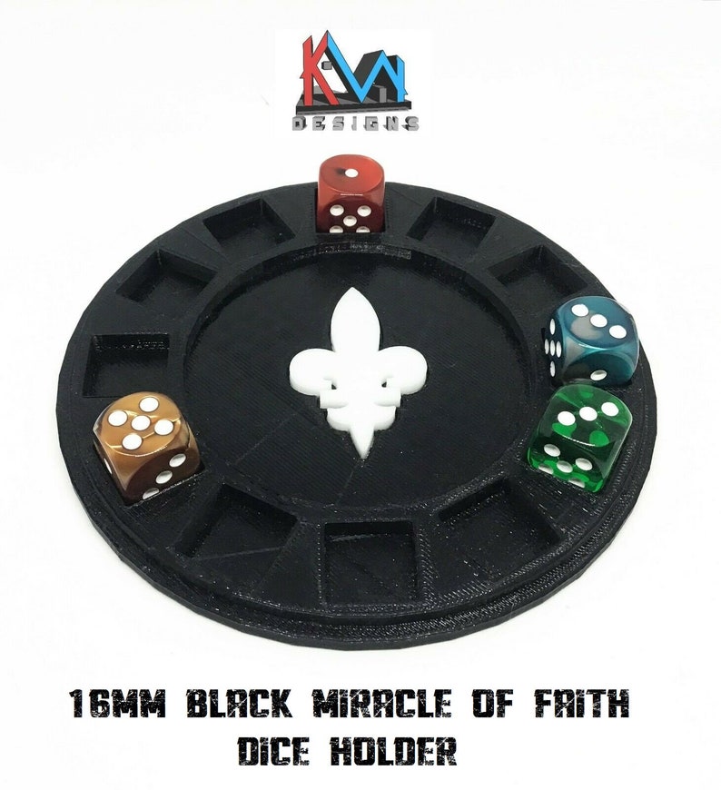 May include: Black dice holder with a white fleur-de-lis in the center. The holder has several compartments, each holding a die. The dice are various colors, including red, green, and brown. The text "16MM BLACK MIRACLE OF FAITH DICE HOLDER" is at the bottom.