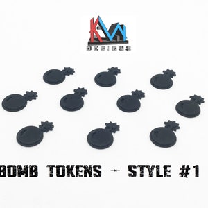 May include: Black bomb-shaped tokens with a starburst fuse, arranged on a white surface. The text "BOMB TOKENS - STYLE #1" is printed below the tokens. The KM Designs logo is in the upper left corner.
