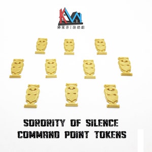 May include: Ten gold-colored command point tokens with a stylized face design are arranged on a white background. The text "SORORITY OF SILENCE COMMAND POINT TOKENS" is printed in black block letters below the tokens. The KM Designs logo is in the upper left corner.