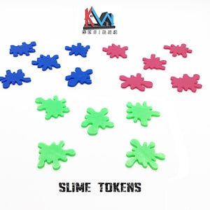 May include: A set of 12 slime tokens in three colors: blue, green, and pink. The tokens are shaped like splatters of slime.