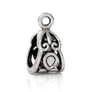 May include: Silver-toned metal pendant with an ornate design. The pendant has a loop at the top for attaching to a chain or cord.