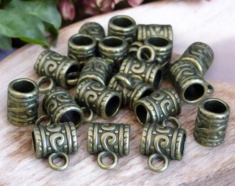 May include: A collection of antique gold-toned metal bead caps with a decorative swirl pattern. Each cap has a small loop for attaching to jewelry.