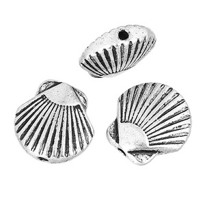 May include: Three silver-colored seashell beads. Each bead has a detailed shell design with ribbed textures. The beads have small holes for stringing. These beads are suitable for jewelry making and craft projects.