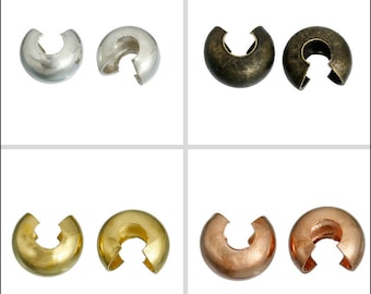 May include: Four pairs of metal bead caps in different finishes: silver, antique brass, gold, and copper. Each cap has a round shape with a split opening for threading beads.