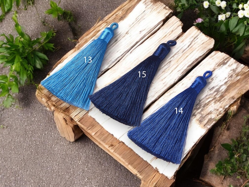 May include: Three tassel trims in different shades of blue. The tassels are labeled with numbers 13, 15, and 14.