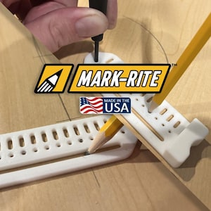 May include: A white Mark-Rite tool with a pencil inserted, used for drawing circles. The tool has a ruler-like design with multiple holes and the text "MARK-RITE" and "MADE IN THE USA" on the image.
