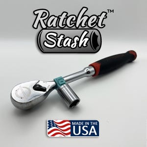May include: A chrome ratchet wrench with a black and red handle and a socket attached. The wrench has a teal colored ring. The image includes the text "Ratchet Stash" and "Made in the USA" with an American flag.
