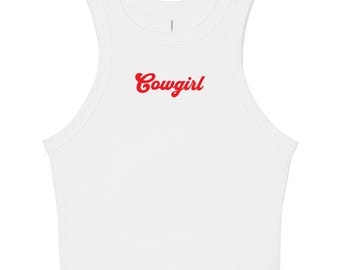 May include: White crop top with a high neckline and the word "Cowgirl" in red script across the front. The top is sleeveless and made of a soft, likely stretchy material.