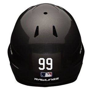 May include: Black baseball helmet with a white number 99 on the front. The helmet has a Rawlings logo on the bottom.