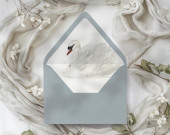 May include: A light blue envelope with a white swan illustration inside. The swan is painted in a watercolor style with a red beak.