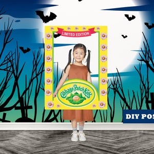 May include: A young girl poses with a Cabbage Patch Kids photo frame against a Halloween-themed backdrop. The frame is yellow with daisy accents and the words "Limited Edition." The background features bats, a full moon, and silhouettes of trees and tombstones. The words "DIY POSTER" are also visible.