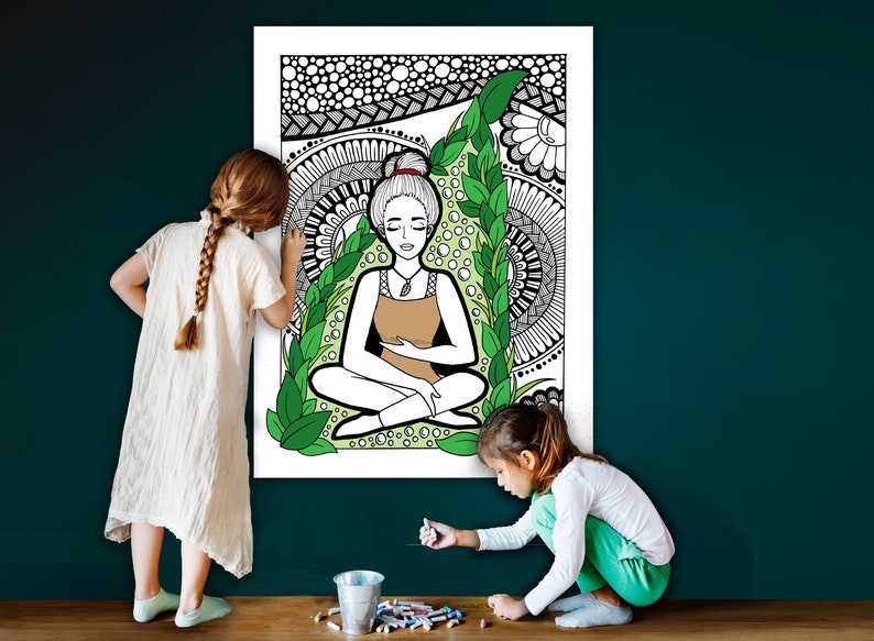 May include: Two children color a large poster with a black and white line drawing of a woman meditating in a circle of green leaves. The poster is on a teal wall.