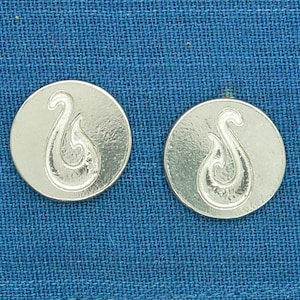 May include: A pair of silver-coloured earrings featuring a stylised fish hook design. The earrings are round and have a smooth finish.