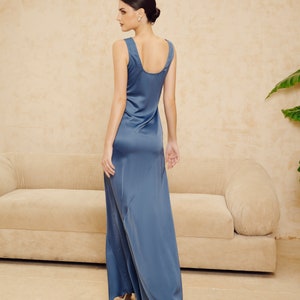 May include: A long, flowing, blue satin dress with a scoop neck and a simple, elegant design.