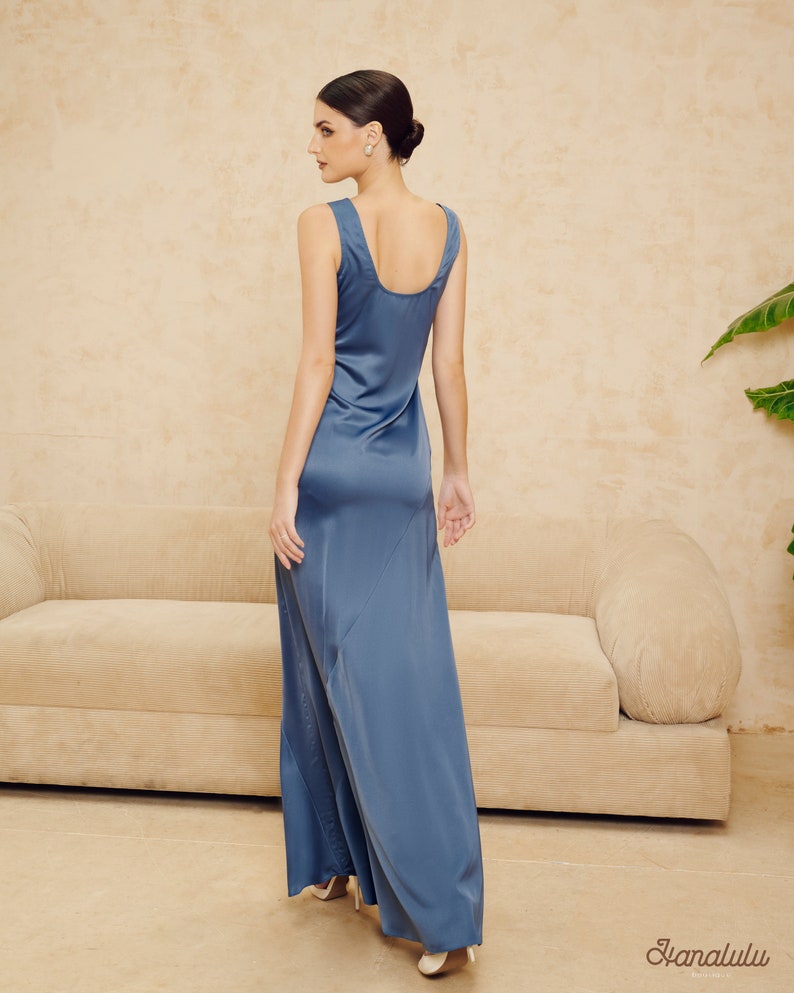 May include: A long, flowing, blue satin dress with a scoop neck and a simple, elegant design.