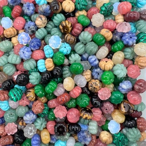 May include: A large assortment of colorful gemstone beads in various shapes and sizes. The beads are made of natural stones and have a polished finish. They are perfect for making jewelry, crafts, and other projects.