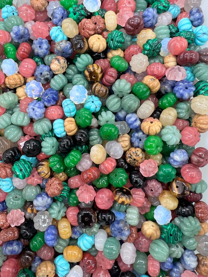 May include: A large assortment of colorful gemstone beads in various shapes and sizes. The beads are made of natural stones and have a polished finish. They are perfect for making jewelry, crafts, and other projects.