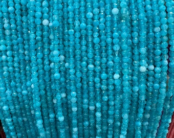 May include: A strand of light blue gemstone beads. The beads are round and have a smooth, polished finish.