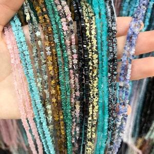 May include: A selection of star-shaped gemstone bead strands in colours such as pink, turquoise, black, and green. The beads are strung together, creating a textured and colourful display. Suitable for jewellery making.
