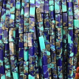 May include: A strand of turquoise and lapis lazuli gemstone beads. The beads are rectangular and have a mottled pattern of blue, turquoise, and gold.