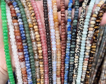 May include: A variety of gemstone beads in different colors and patterns, including green, blue, red, brown, and white. The beads are all faceted and have a smooth, polished finish.