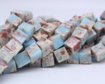 Può includere: Un mucchio di perline quadrate di colore blu chiaro e marrone con un motivo marmoreo. Le perline sono fatte di pietra naturale e sono perfette per la creazione di gioielli.