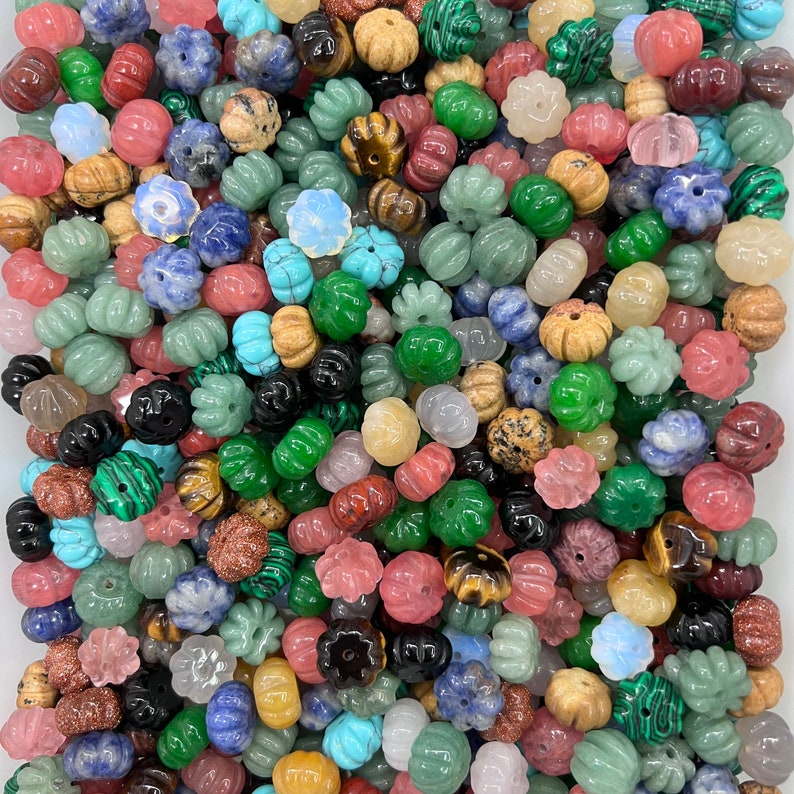 May include: A large assortment of colorful gemstone beads, including green, blue, red, and brown. The beads are made of various materials, such as agate, jasper, and quartz. They are perfect for jewelry making, crafting, and home decor.