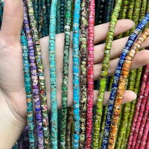May include: A selection of colourful, multi-coloured, and patterned gemstone beads. The beads are round and have a smooth, polished finish. They are strung on a string and are ready to be used for jewellery making.