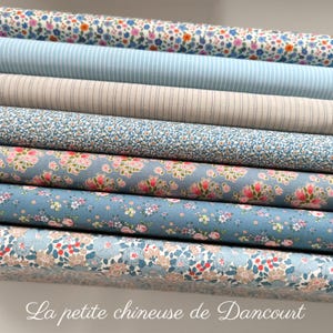 May include: A stack of eight fabric rolls featuring a variety of floral and striped patterns in shades of blue, white, and pink. The fabric rolls are arranged in a staggered pattern, with the top roll being the most prominent. The text "La petite chineuse de Dancourt" is visible at the bottom of the image.