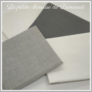 Peut inclure: Trois échantillons de tissu dans différentes nuances de gris. Les échantillons sont disposés en forme de triangle. L'échantillon du haut est gris foncé, l'échantillon du milieu est gris clair avec une texture subtile, et l'échantillon du bas est gris très clair.