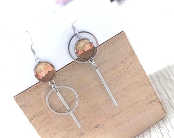 Geometric asymmetrical hoop earrings with brown jasper, gold mother-of-pearl, and copper leaf medallions.