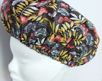 May include: A black shower cap with a floral pattern in shades of red, pink, white, and gold. The pattern features leaves, flowers, and dots.