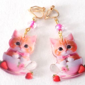 Clip-on earrings, kitten motif, glass pearl, gold and pink colors.