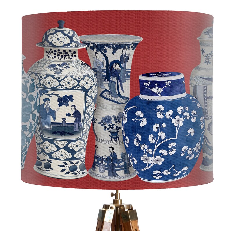 May include: A red lampshade with a pattern of blue and white Chinese porcelain vases. The vases are decorated with floral and geometric designs.