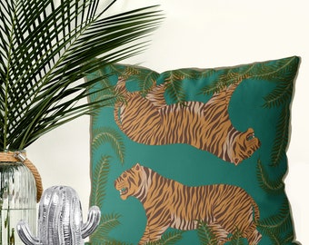 May include: Teal cushion with a repeating pattern of orange and brown tigers in a jungle setting. The tigers are depicted in a stylised, almost cartoon-like fashion.