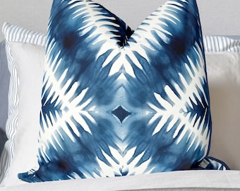 May include: A blue and white patterned throw pillow with a geometric design. The pillow is made of a soft, comfortable fabric and has a subtle sheen.