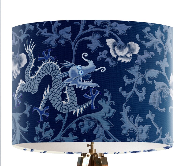 May include: A blue and white lampshade with a dragon and floral pattern. The dragon is in a light blue color and the floral pattern is in a darker blue color.