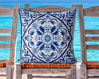 May include: A blue and white patterned throw pillow with a geometric design. The pillow is sitting on a wooden chair with a woven seat.