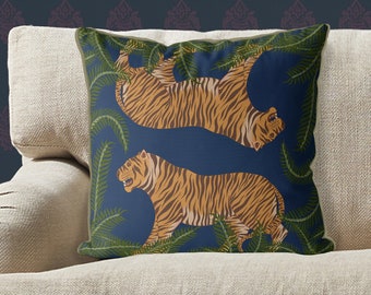 May include: A navy blue cushion with a repeating pattern of two orange and black tigers in a jungle setting. The tigers are depicted in a stylised, almost cartoon-like manner.