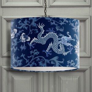 May include: A blue and white lampshade with a dragon design. The dragon is in a traditional Chinese style and is surrounded by floral patterns.