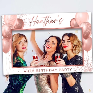 May include: A white photo booth prop with a rose gold frame and confetti. The frame has a cut-out for a photo and says "Heather's 40th Birthday Party".
