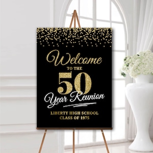 May include: Black and gold welcome sign with gold glitter accents. The sign reads "Welcome to the 50 Year Reunion Liberty High School Class of 1975".