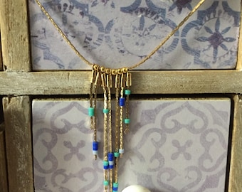 The necklace gold and these blue beads