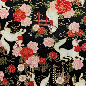 May include: Black fabric with a repeating pattern of white foxes with red accents, red and pink flowers, and gold swirls. The foxes have red scarves and masks. The flowers include peonies and other blossoms.