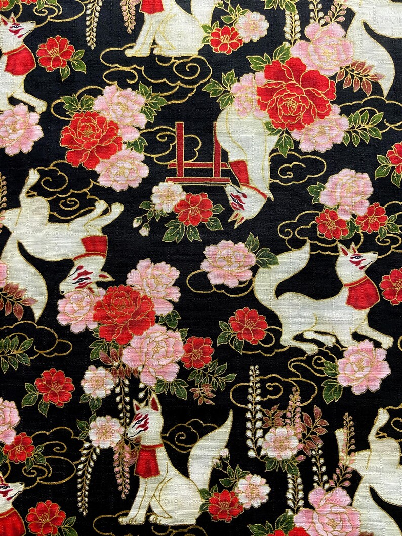 May include: Black fabric with a repeating pattern of white foxes with red accents, red and pink flowers, and gold swirls. The foxes have red scarves and masks. The flowers include peonies and other blossoms.