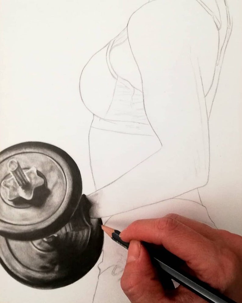 May include: A close-up of a hand drawing a black and silver dumbbell with a pencil. The dumbbell is in the foreground and the hand is in the background.