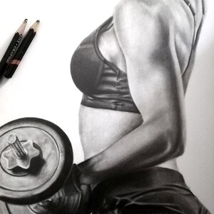 May include: A black and white drawing of a person lifting a dumbbell. The person is wearing a black sports bra and black shorts. The person's muscles are defined in the drawing.