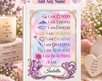 Puede incluir: Un diario de tapa dura blanca con un fondo de acuarela y el texto: I AM LOVED, I AM STRONG, I AM ENOUGH, I AM WORTHY, I AM CREATIVE, I AM GRATEFUL, I AM RESILIENT, I AM BEAUTIFUL, I AM Isabella, decorado con una mariposa y motivos florales.