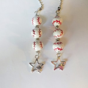 May include: Two white and red baseball themed light pull chains with silver star charms.